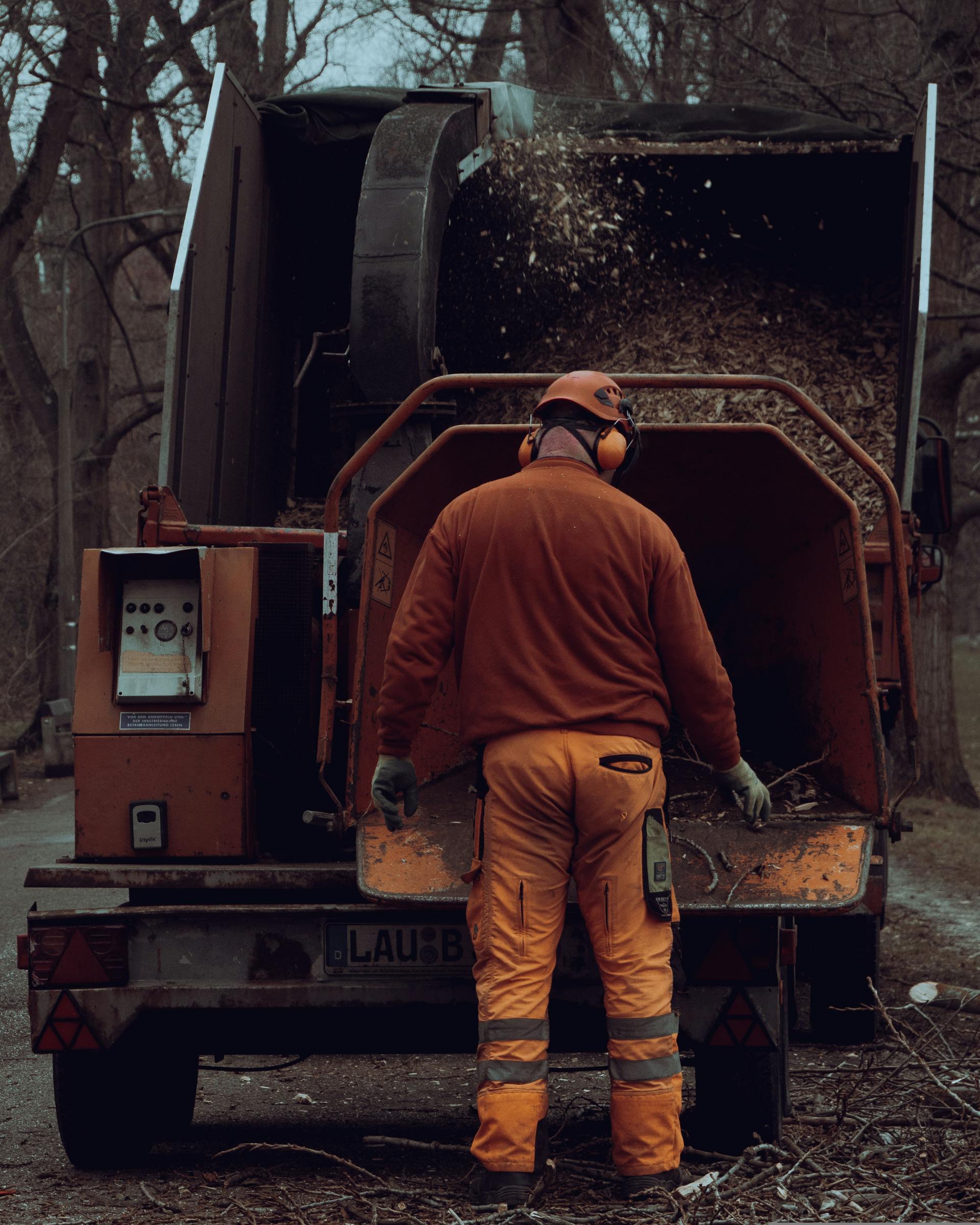 El Monte Tree Experts crew member working with a wood chipper