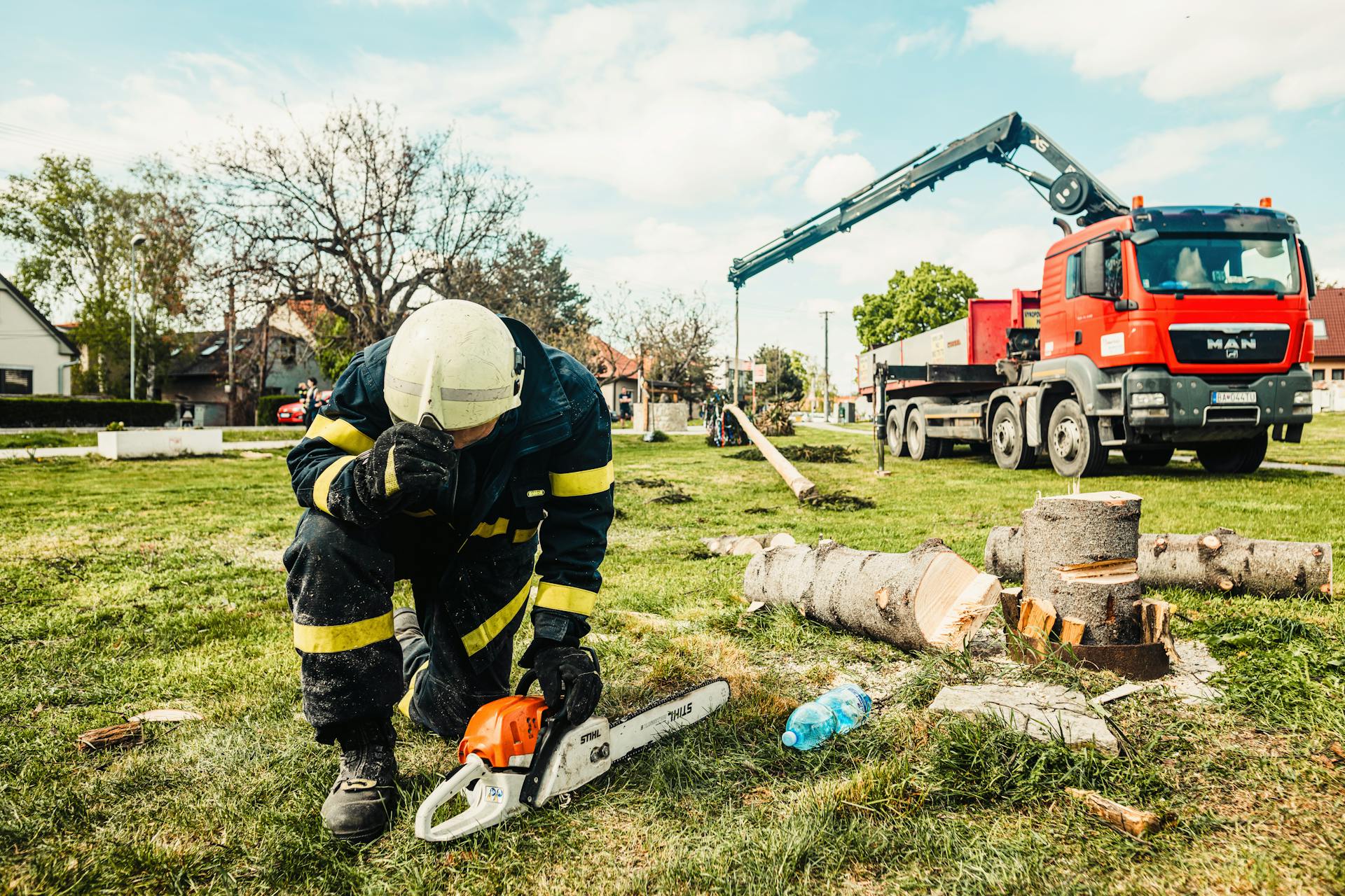 El Monte Tree Experts crew member with chainsaw beside service truck