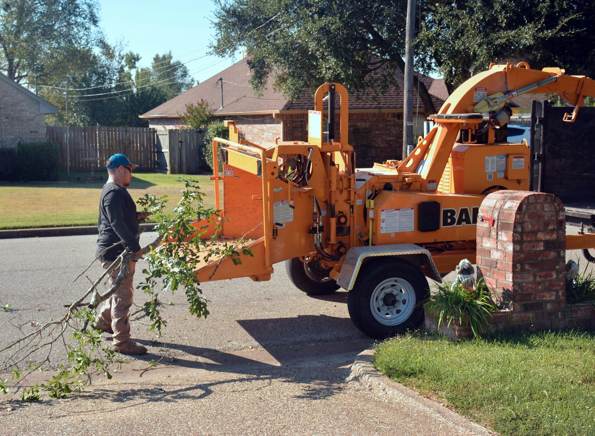 Tree service crew operating wood chipper in an El Monte neighborhood